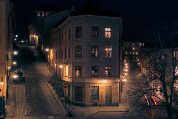 Foto op Aluminium View of illuminated street amidst buildings at night © niklas storm