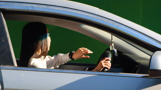 A girl driving a car in a traffic jam. emotions of anger and honking. On a green background