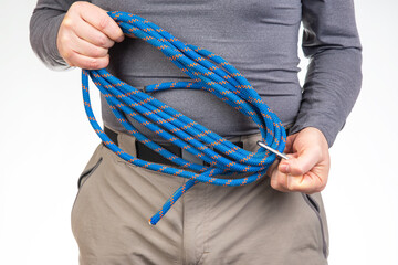 coil of climbing rope in the hands of a tourist.