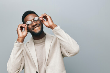 Cheerful african man wearing glasses jean jacket having white snow smile pointing fingers aside at copy space for your text advertisement, advertise teeth whitening or eyewear store good offer concept - obrazy, fototapety, plakaty