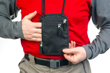 Male tourist with a waist bag for things and documents on a trip. belt bag with a zipper for things...