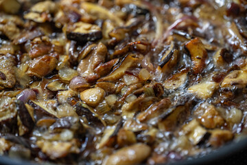 Detail of frying mushrooms and onions.