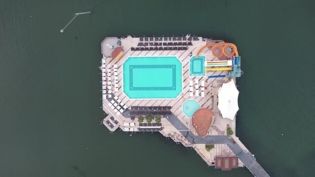 Swimmers practice in olympic pool aerial top down view. Luxury Resort swimming pool with clean beautiful blue water