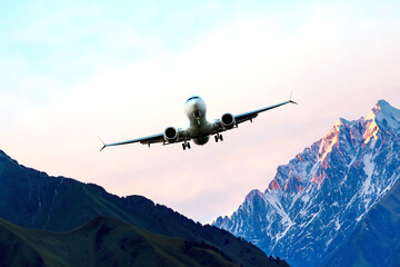 passenger plane flies over the mountains. air transport industry