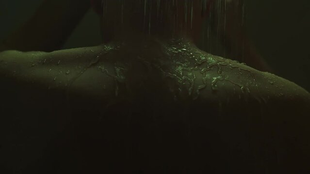 A man taking a shower enjoys the feeling of warm water running down his bare skin. This is the time when he takes care of his appearance, striving for the best condition of his body