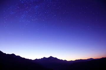 the starry sky in the mountains before the morning dawn. astronomy and planetary observation