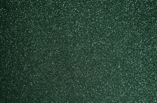 Fototapeta Fondo de brillos / textura glitter de color verde oscuro. Se puede usar como fondo de año nuevo o navidad.