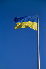 National flag of Ukraine against blue sky