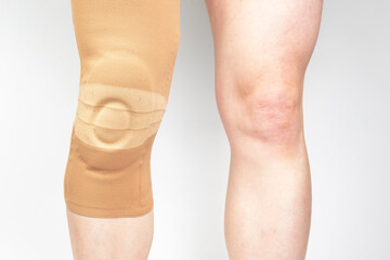 bandage for fixing the injured knee of the human leg on a white background. medicine and sports. limb injury treatment - obrazy, fototapety, plakaty