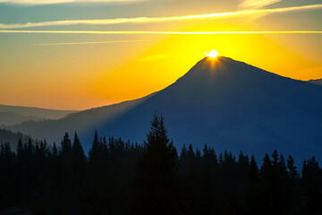 Morning sunrise over the top of a mountain in the Ukrainian Carpathians