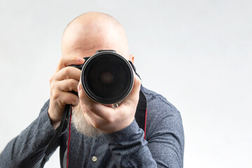 male photographer with a camera in his hands on a white background
