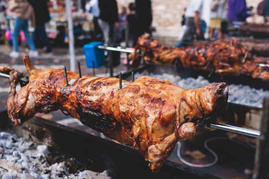 Fototapeta Easter in Greece, process of cooking traditional greek Easter dish - Souvla, grilled lamb, sheep and goat bbq, grilling over charcoal in the streets of Athens, Greece