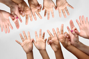 many raised children's expressive hands in a row.