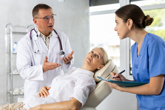 Professional doctor physician consulting female patient, talking to senior adult woman client at medical checkup visit. Geriatric diseases treatment. Elderly medical health care concept