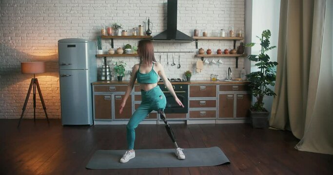 Woman with leg prosthesis performs yoga pose exuding confidence