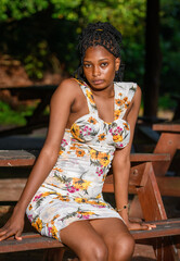 A portrait of  young african lady seated on a park bench