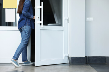 Woman in casual clothes leaving or entering building, closeup