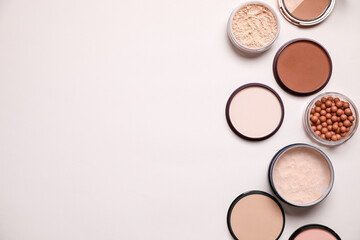 Different face powders on light background, flat lay. Space for text