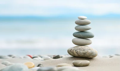 Tuinposter stack of stones on beach © iDoPixBox