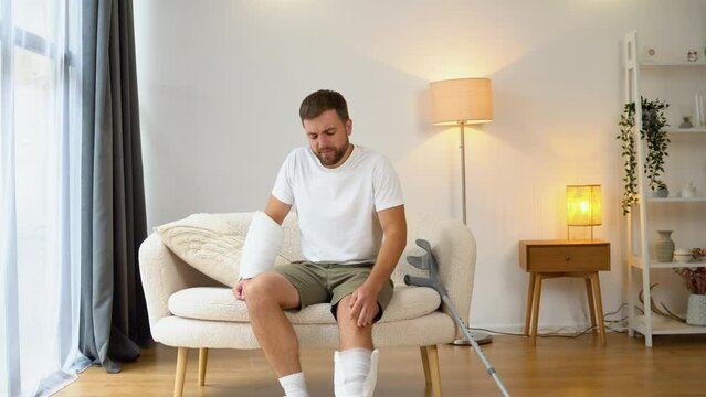 A man with crutch suffer pain from a broken leg