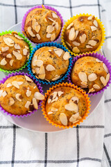 Lemon poppy seed muffins garnished with almond slivers