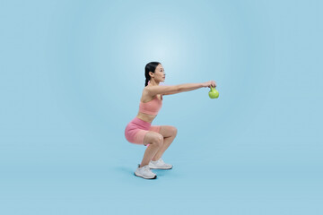Fototapeta na wymiar Vigorous energetic woman doing kettlebell weight lifting exercise on isolated background. Young athletic asian woman strength and endurance training session as body workout routine.