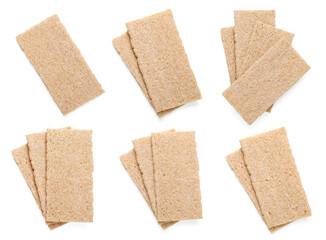 Tasty crispbreads on white background, top view