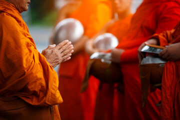 Buddhist monk holding alms bowl waitting for buddhism make merit by offering food and water at...