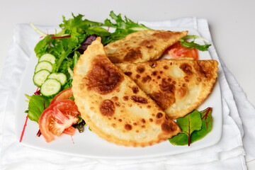 Latin cuisine is tortillas fried dough with meat.