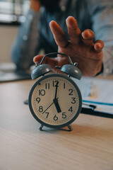 Business working times concept people work typing on laptop computer overlay with in time clock to...