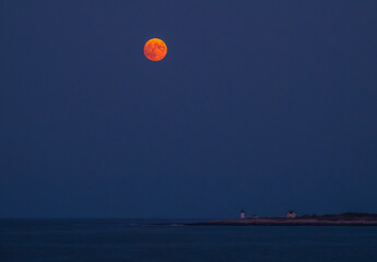 The Harvest Moon rising above the Straitsmouth Island Light in Rockport MA