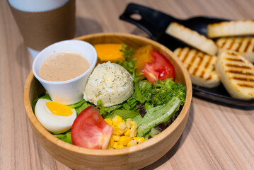Fresh salad in the wooden bowl