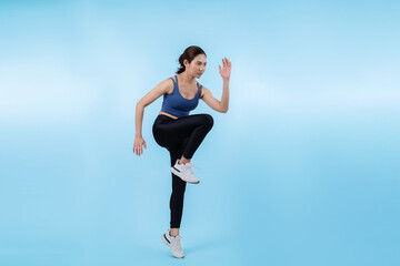 Fototapeta na wymiar Side view young athletic asian woman on running posture in studio shot on isolated background. Pursuit of healthy fit body physique and cardio workout exercise lifestyle concept. Vigorous