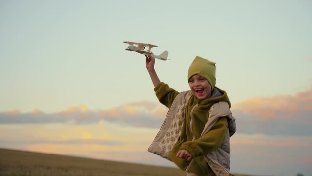 Little boy running with an airplane
