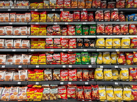 Budva, Montenegro - 18 august 2023: Assortment of packs with different chips on the shelves in the store