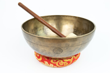 Tibetan handcrafted full moon singing bowl with white stick isolated on white background