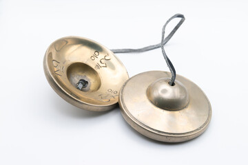 Tibetan Buddhist tingsha (tibetan cymbals) with leather strap isolated on white