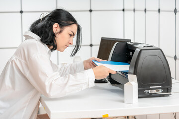 female designer use plotter to create prototype