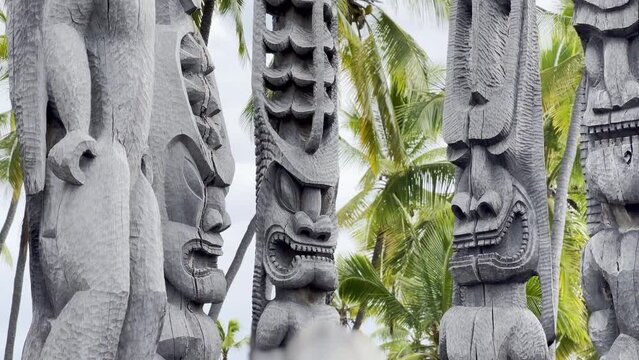 Cinematic close-up booming up shot of the tiki statues on the royal grounds of Pu'uhonua O Honaunau in Hawai'i. 4K HDR at 30 FPS