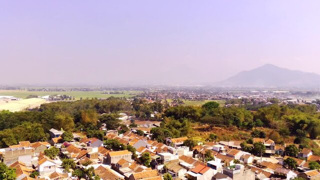 Drone Videography. Aerial shot. Aerial Footage Village at the foot of the mountain in the Cikancung area - Bandung, Indonesia. Shot in 4k resolution from a flying drone. Asia