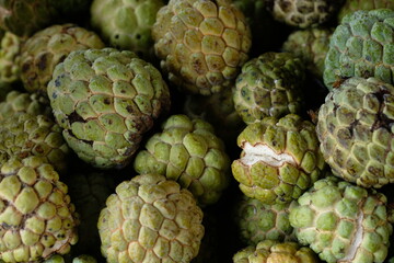 Srikaya is a plant belonging to the genus Annona which originates from tropical areas. Annona squamose. Sugar apple fruits. Blurred image of fruits. 