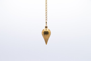 Brass pendulum on chain isolated on white background.