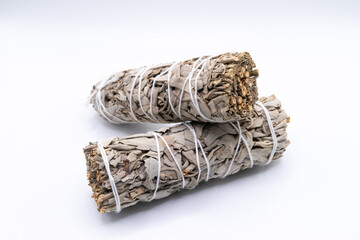Bundles of dry white sage close-up isolated on white background. Normally used for purification, meditation and healing