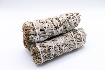 Bundles of dry white sage close-up isolated on white background. Normally used for purification, meditation and healing