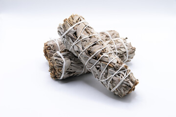 Bundles of dry white sage close-up isolated on white background. Normally used for purification, meditation and healing