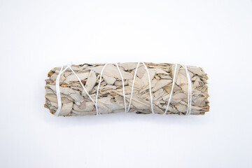 Bundle of dry white sage close-up isolated on white background. Normally used for purification, meditation and healing