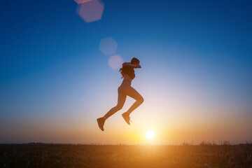 jumping young women jumping in nature doing gymnastics during early morning