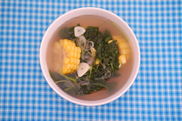 Sayur Bening Daun kelor jagung or Moringa Oleifera clear soup with sweet corn served in bowl