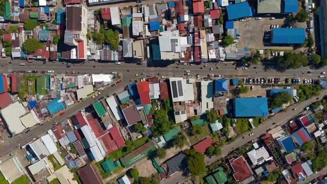 Overhead shot of the streets and buildings of Surigao City in the Philippines, aerial top down