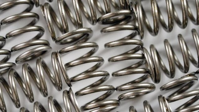 Collection of steel spring parts on a turntable - macro